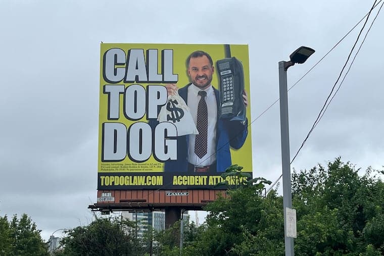 Top Dog Law actual billboard - CALL TOP DOG with headshot, money bag, and giant phone on yellow background